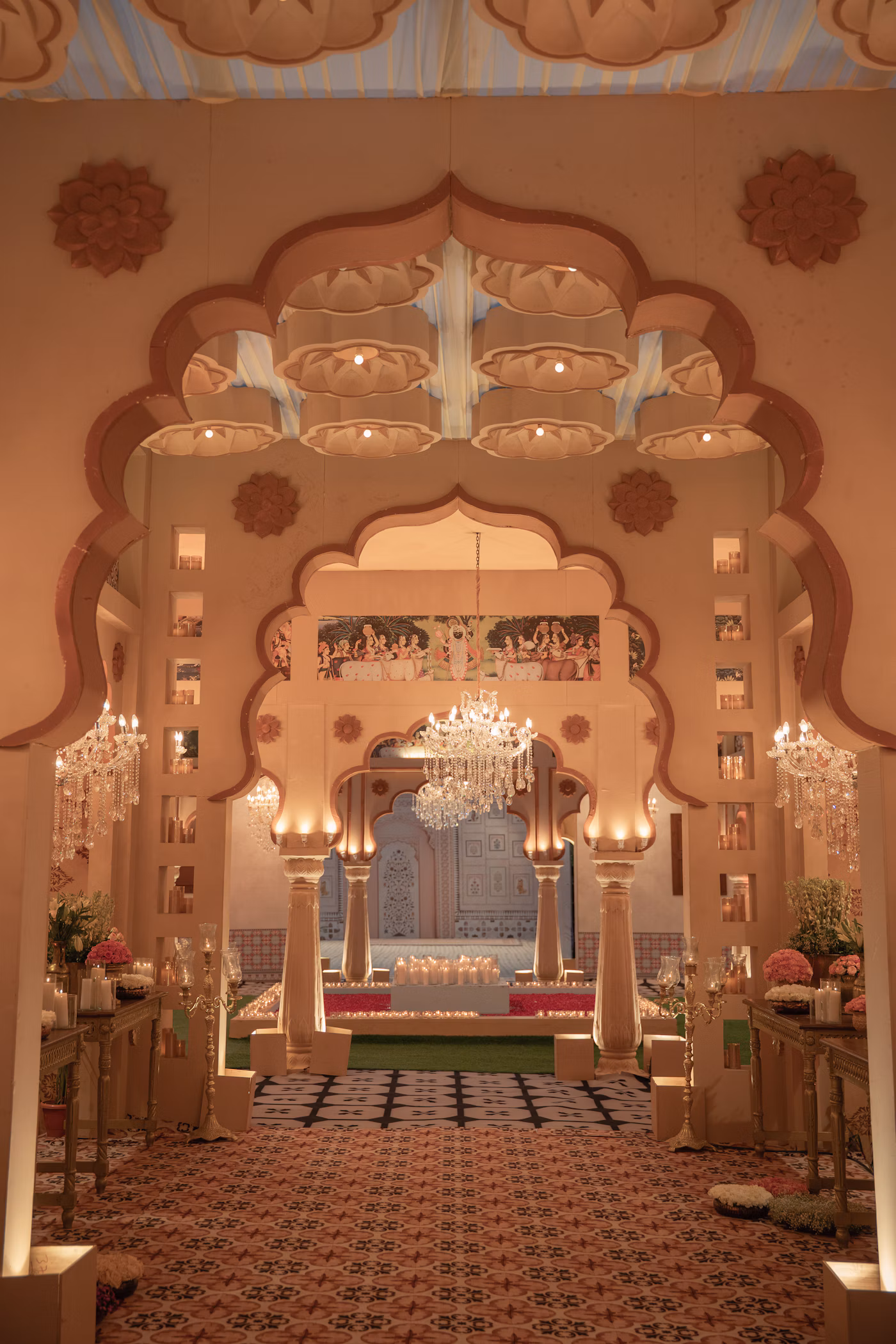 Ornate royal palace archway entrance with crystal chandeliers and celebration seating